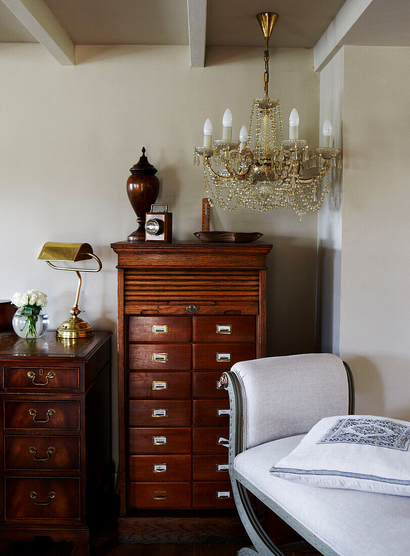 Tallboy and chandelier in country cottage