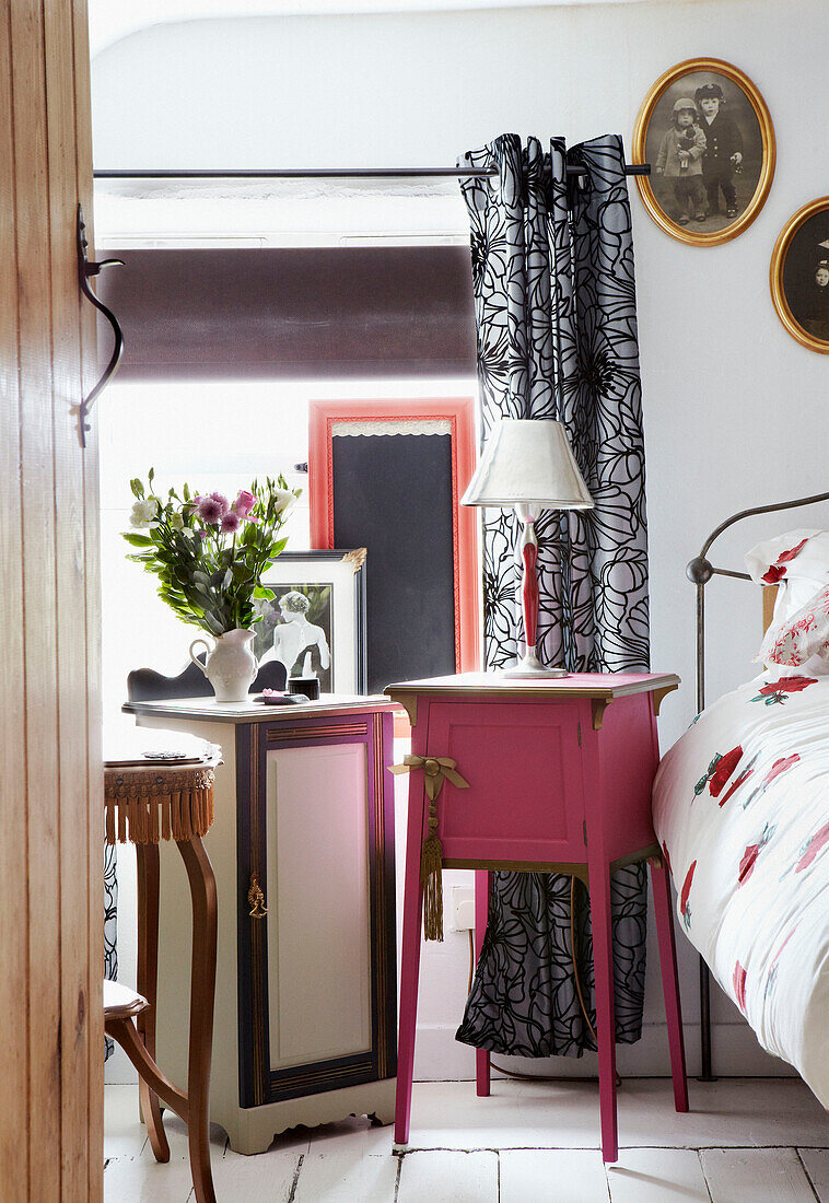 Painted bedside cabinets in bedroom of country cottage