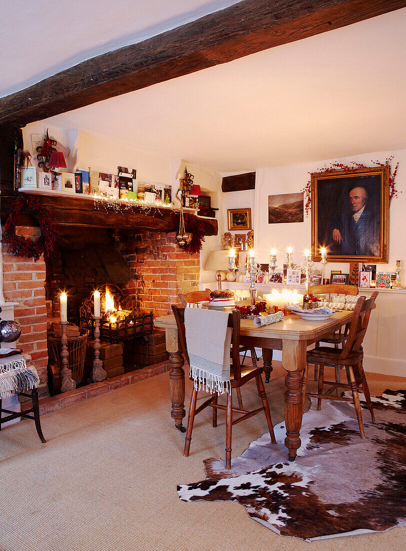 Lit candles in dining room of beamed home