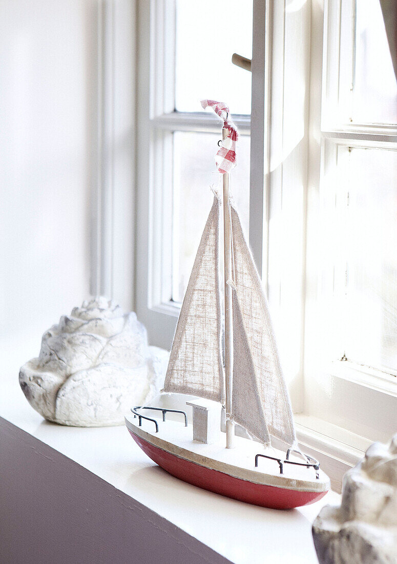 Model boat on sunlit windowsill