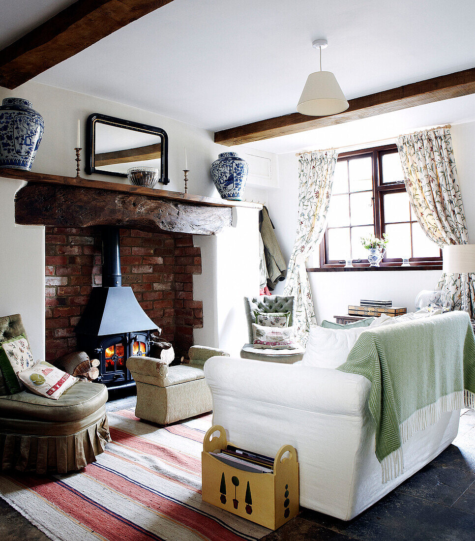 Wood burner in brick fireplace of country home