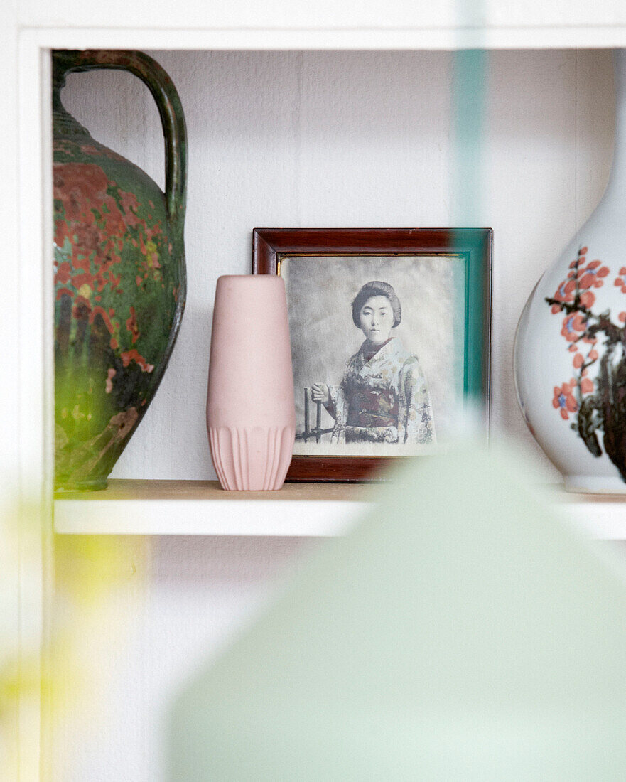 Portrait of an oriental woman with vases on shelf, Amsterdam, Netherlands