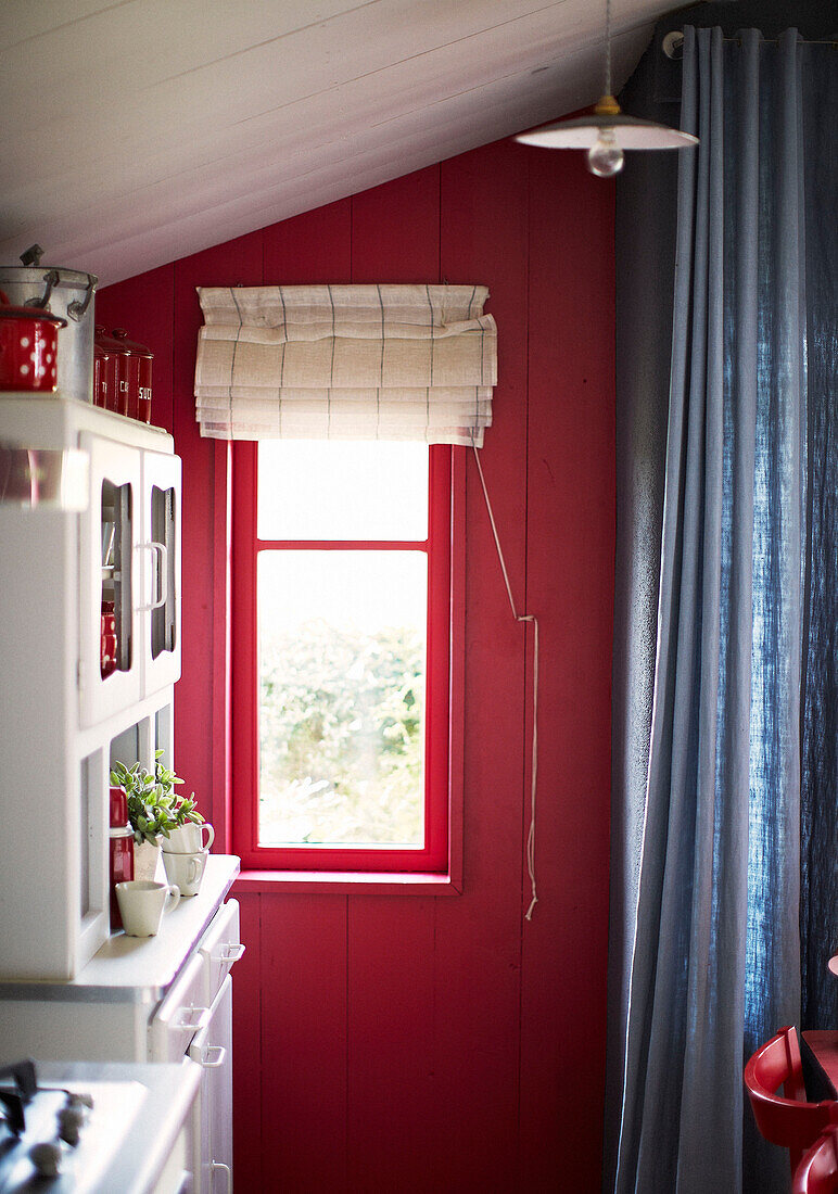 Kitchen dresser and curtains at window of Brittany schoolhouse conversion France