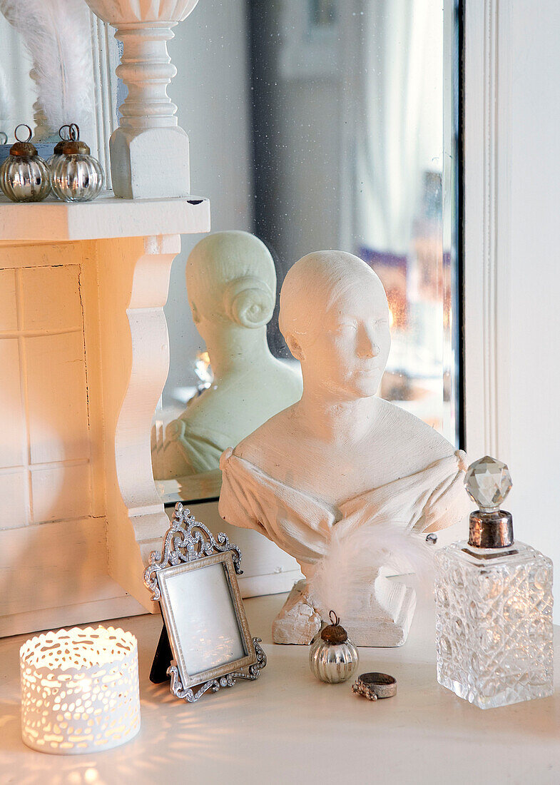 Bust of a woman with silver photoframe and glass perfume bottles in Derbyshire farmhouse England UK