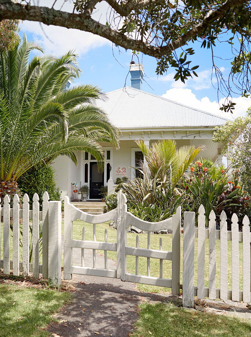 White picket fence surrounding Warkworth bungalow Auckland North Island New Zealand