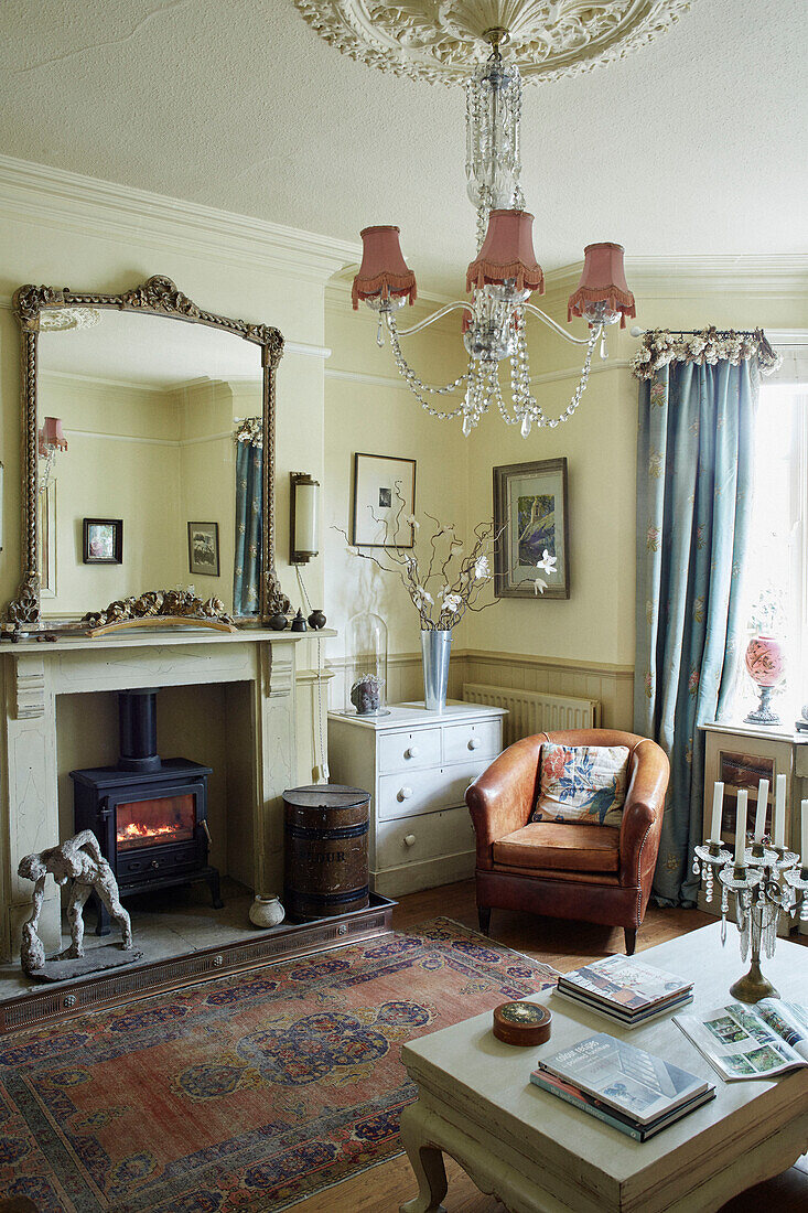 Mirror above lit woodburner in Whitley Bay living room Tyne and Wear England UK