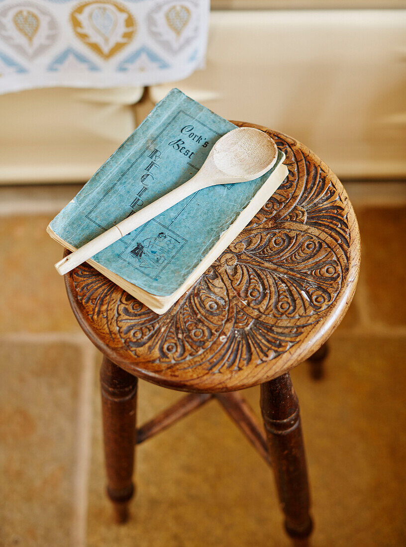 Wooden spoon with recipe book on carved stool in Hexham Northumberland UK