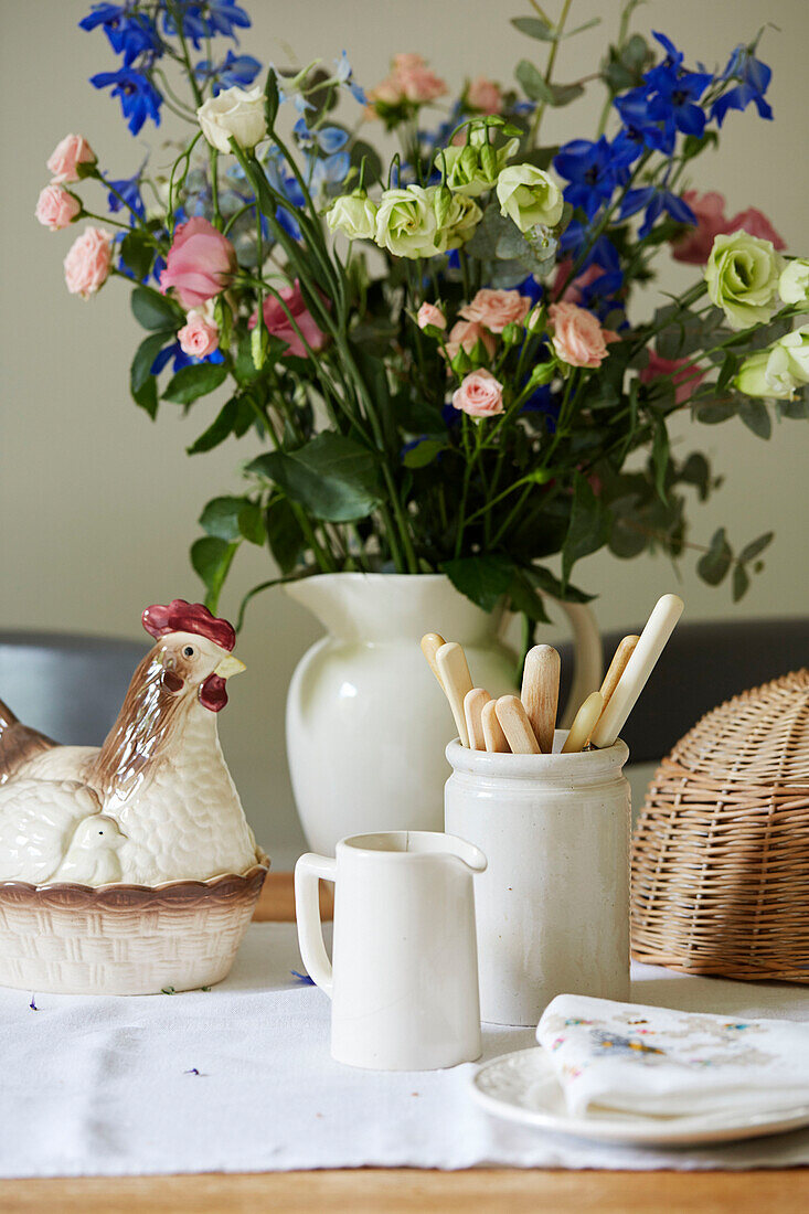 Egg basket and cut flowers on table in Northumberland cottage, Tyne and Wear, England, UK