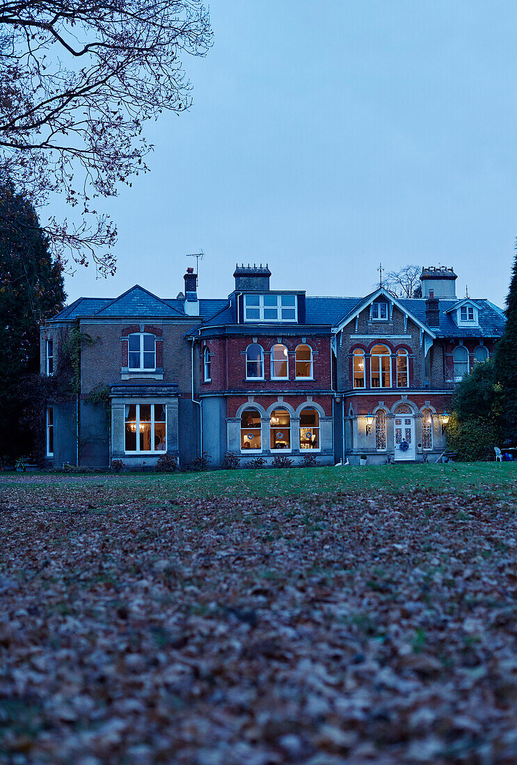 Fallen leaves on lawn in garden of East Grinstead detached house, West Sussex, UK