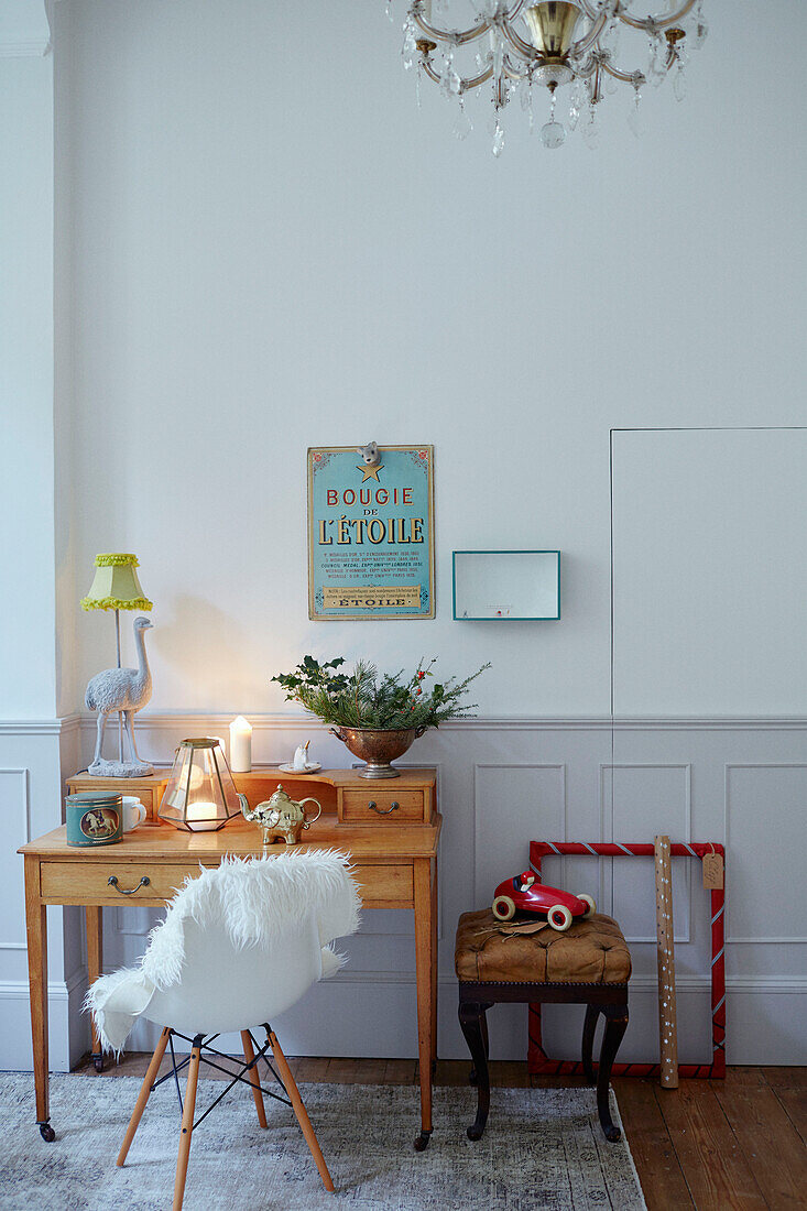 DSW chair at wooden desk with vintage French sign in East Grinstead home, West Sussex, UK