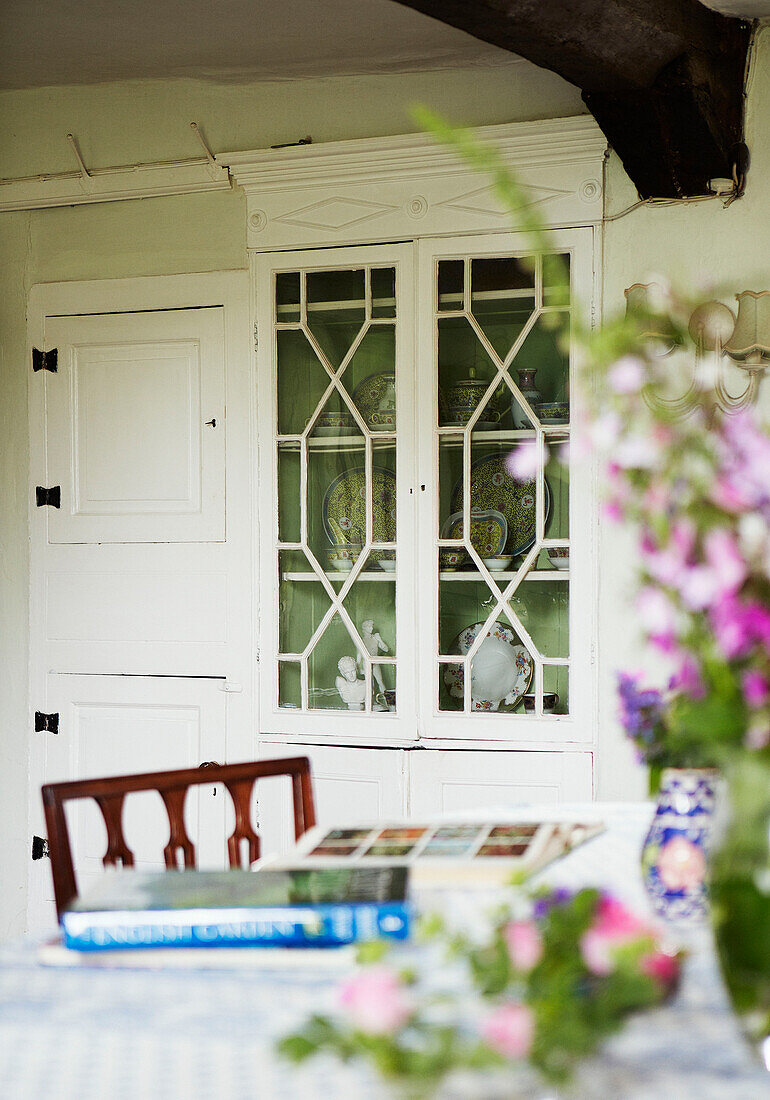 Chinaware in glass fronted cabinet in Syresham home, Northamptonshire, UK