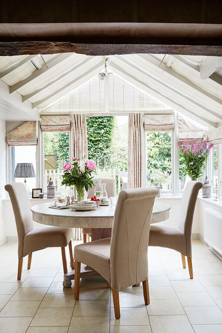 Circular dining table and chairs in Berkshire cottage, England, UK