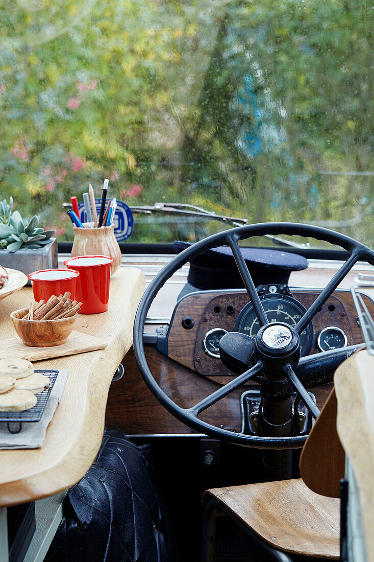 Kitchen worktop beside the steering wheel inside The Majestic bus near Hay-on-Wye, Wales, UK