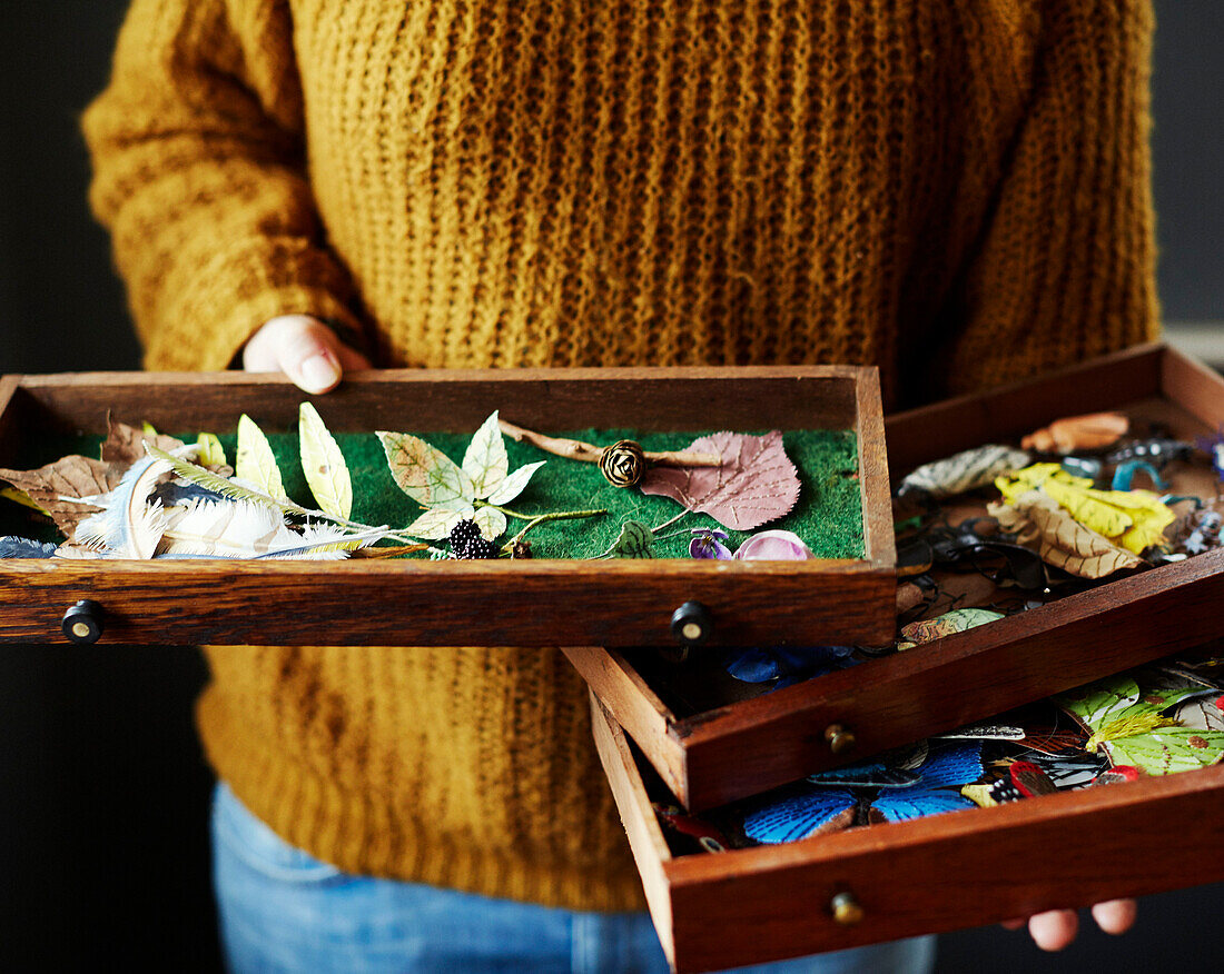 Woman holding drawer of handmade paper leaves in Gladestry studio on South Wales borders