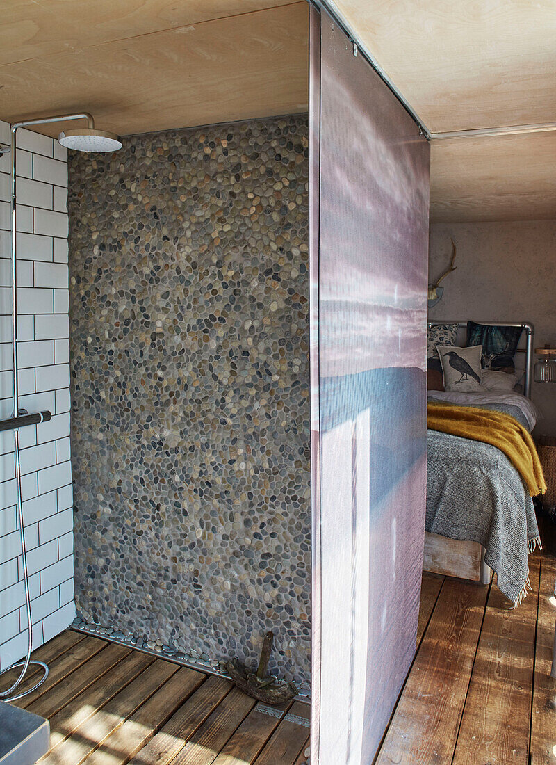 Pebble dashed wall in shower cubicle converted shipping container in Bedford, UK