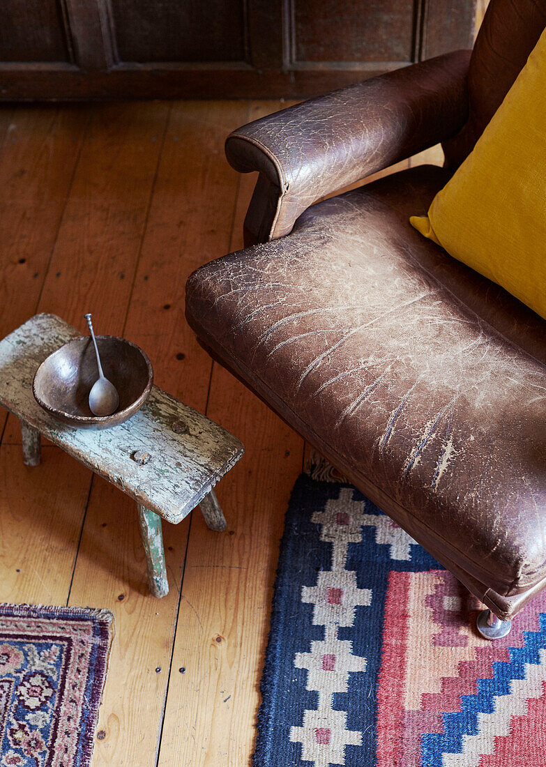 Empty bowl with spoon and chair in Devon home, UK