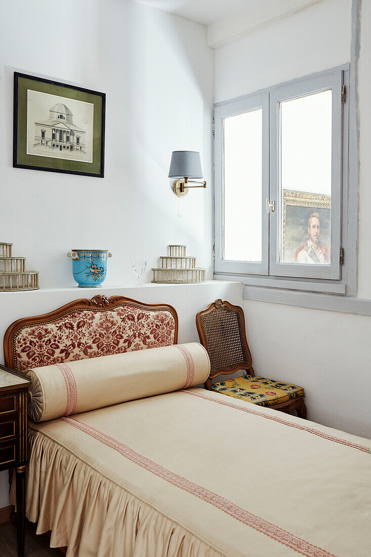 Floral headboard and bolster on single bed in Foix townhouse Ariege, France