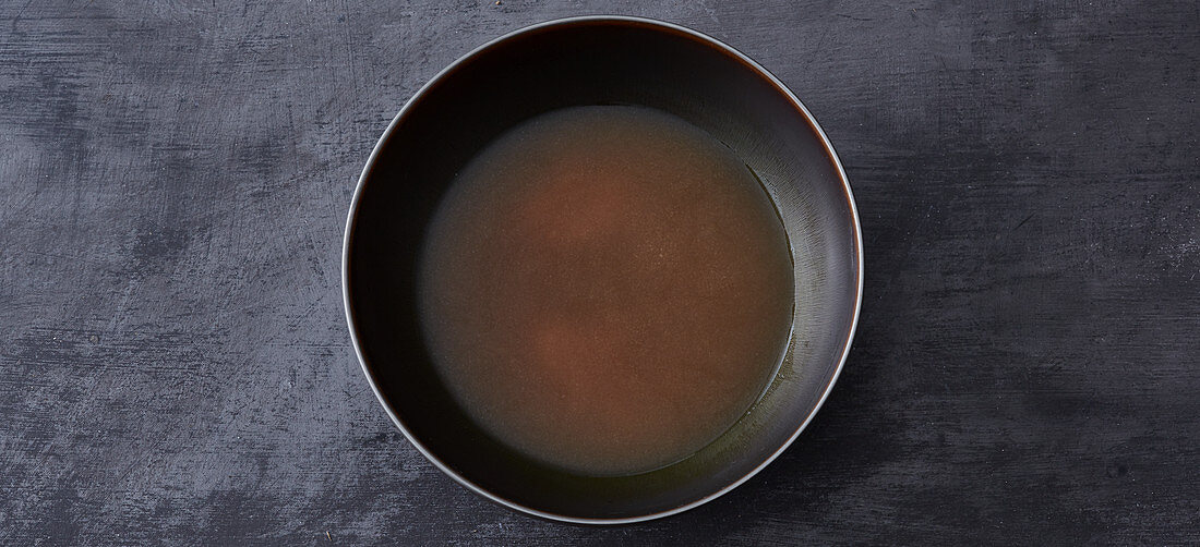 Ramen being served – broth being added to tare