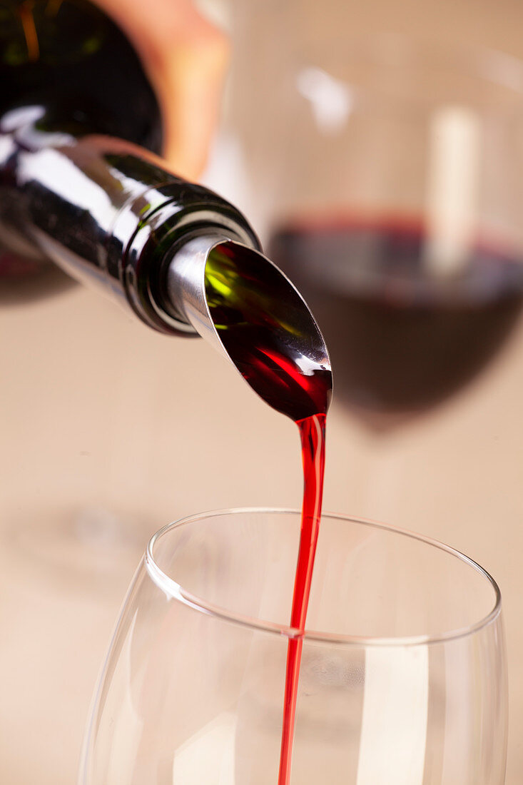 Red wine being poured using a drip-free pourer