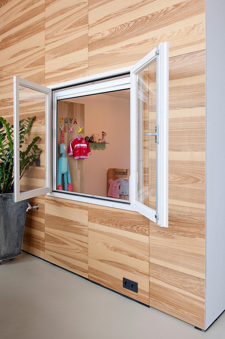 Room within a room with open interior window looking into child's bedroom