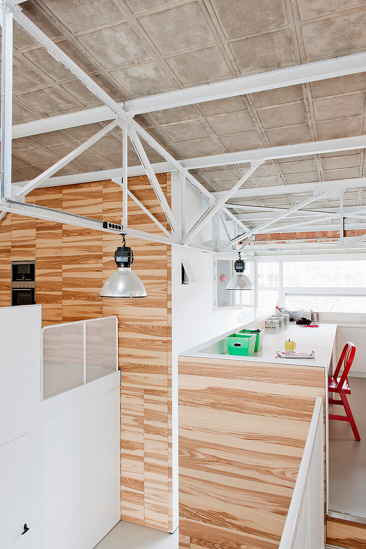 Desk on gallery in modern loft apartment with wood-clad walls