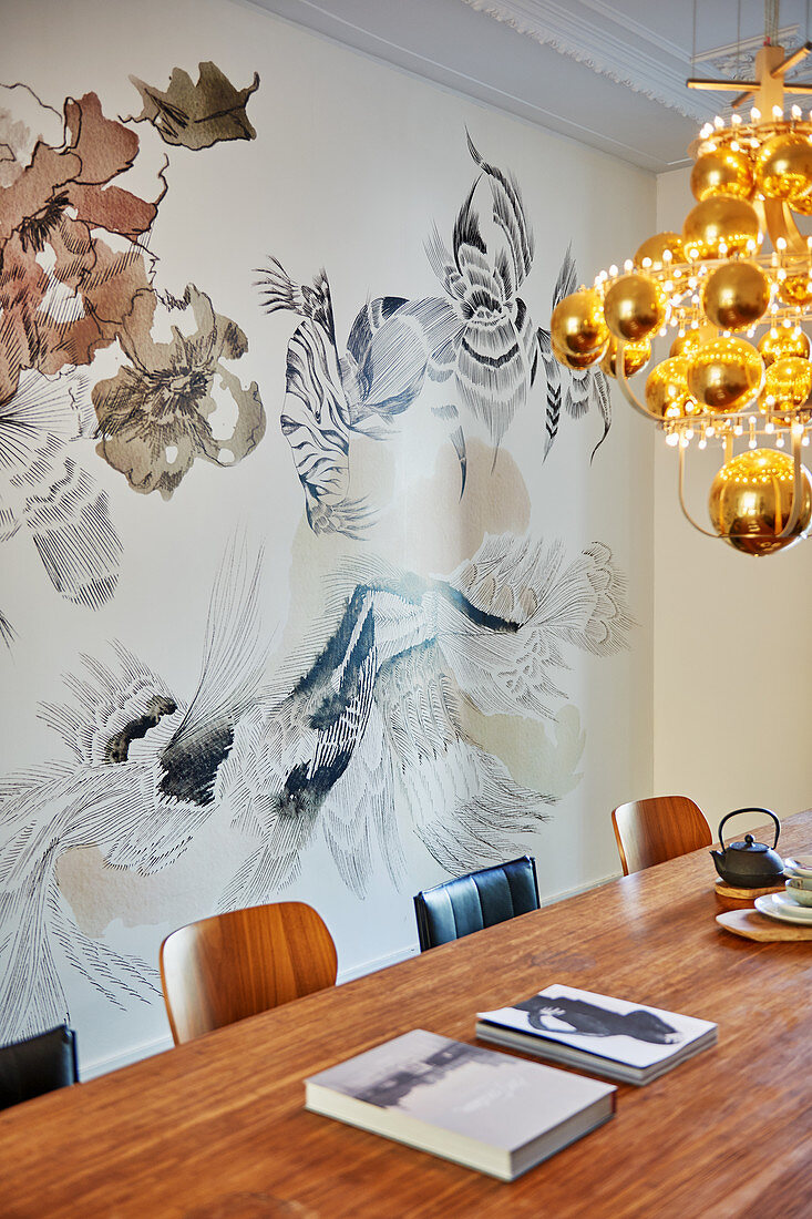 Modern chandelier of golden spheres above dining table