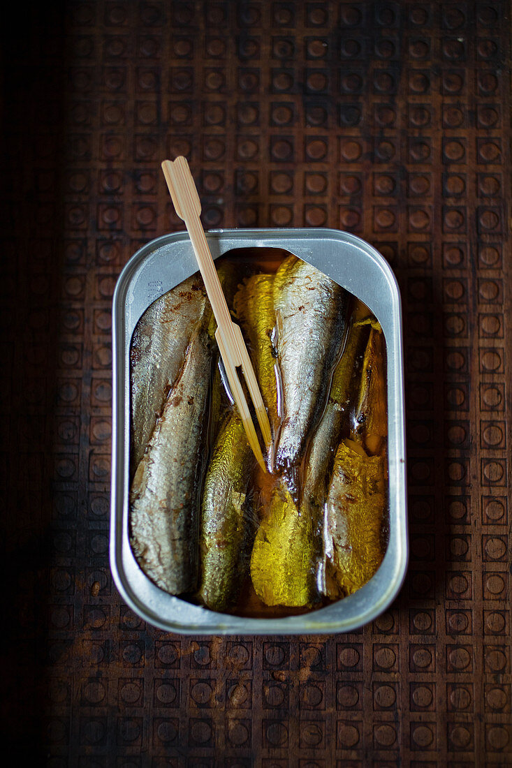 Sardines in a tin with a wooden fork