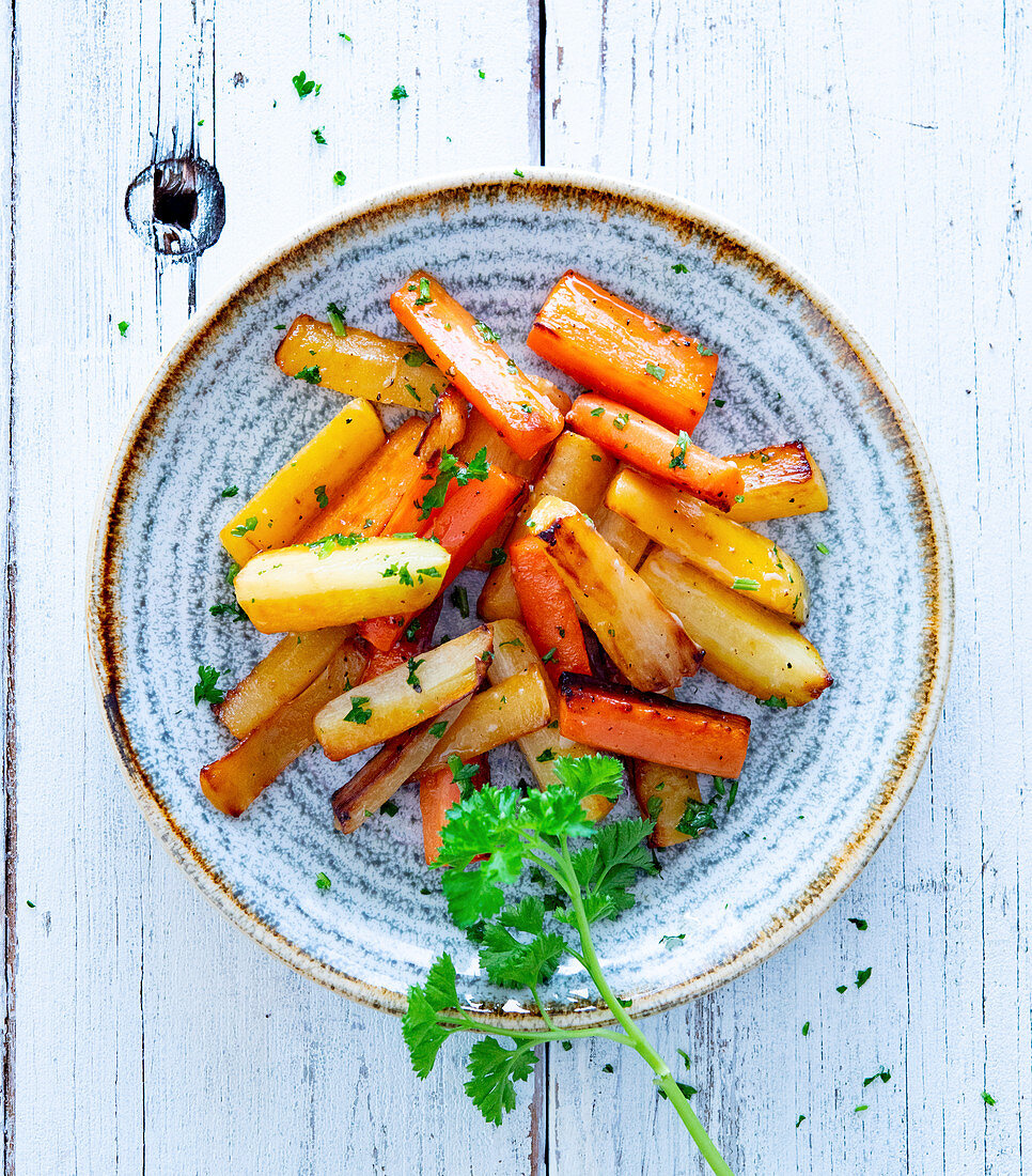 Colourful roasted carrot sticks with parsley