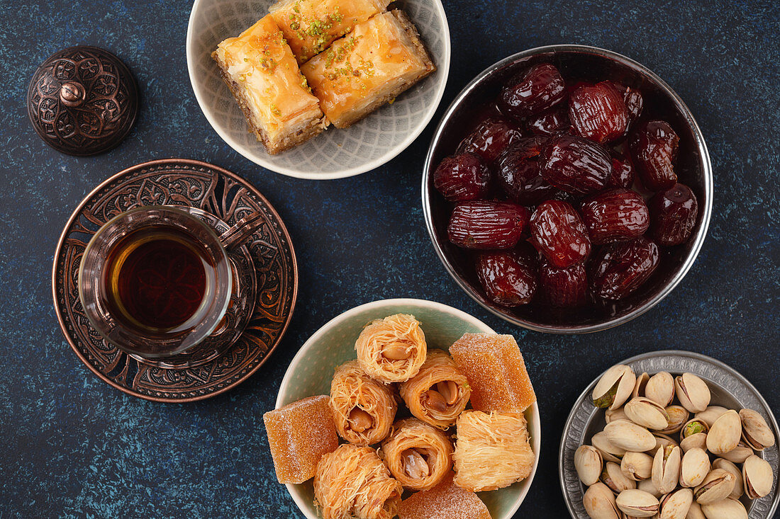Traditional Arab fresh hot tea time with sweets, baklava, dates and lokum
