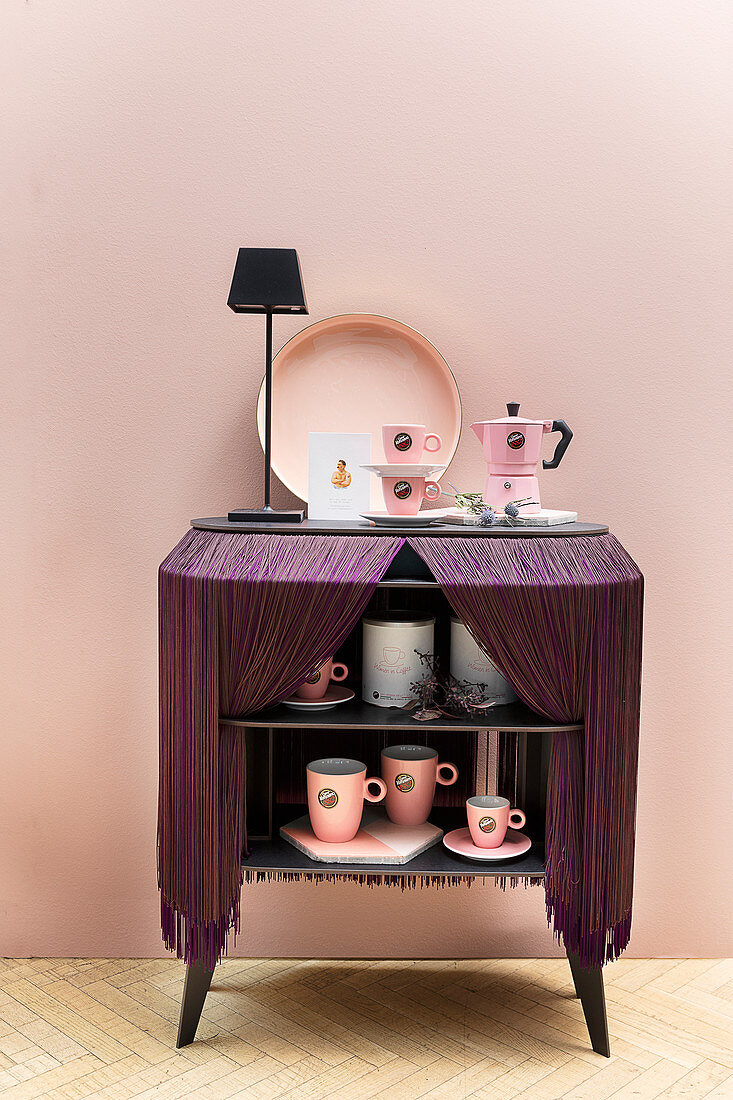 Small sideboard covered with fringed cloth