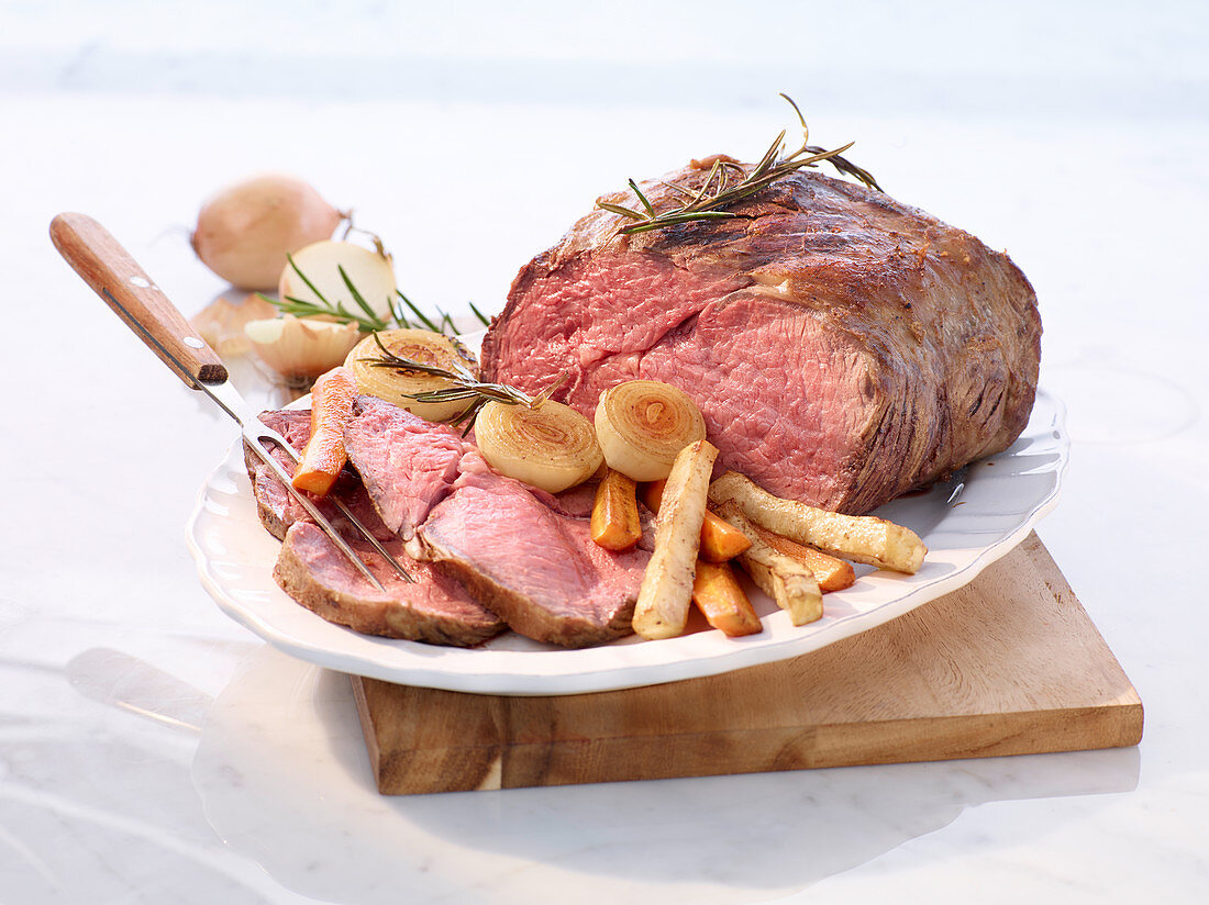 Roast beed with root vegetables, onions and rosemary