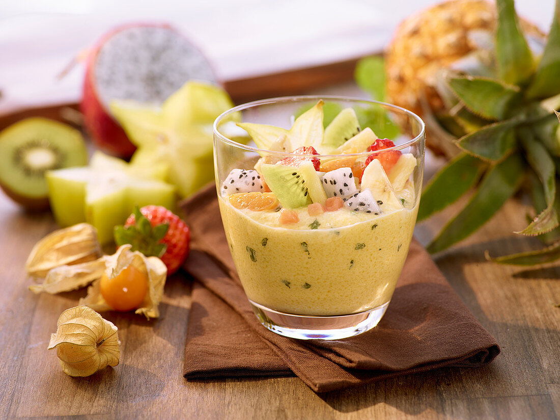 Mango mousse with fruit salad in a glass