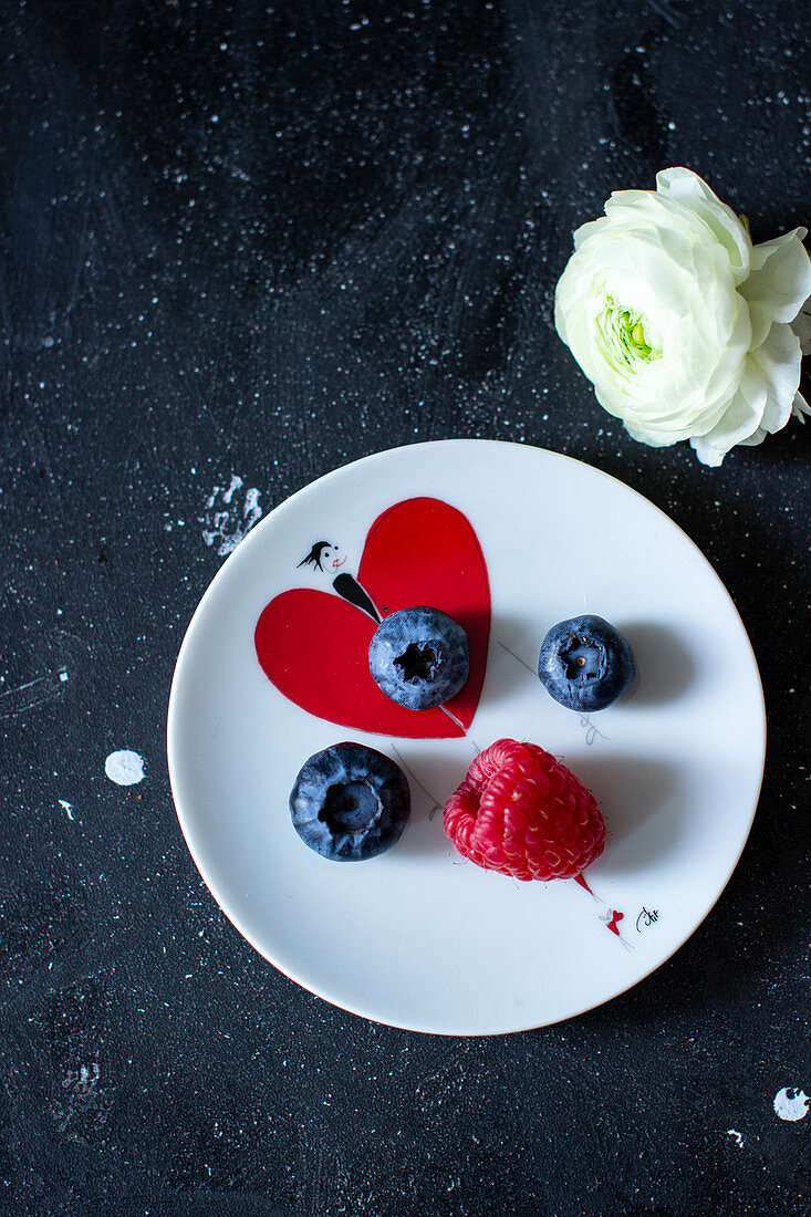Fresh berries on a plate with a heart