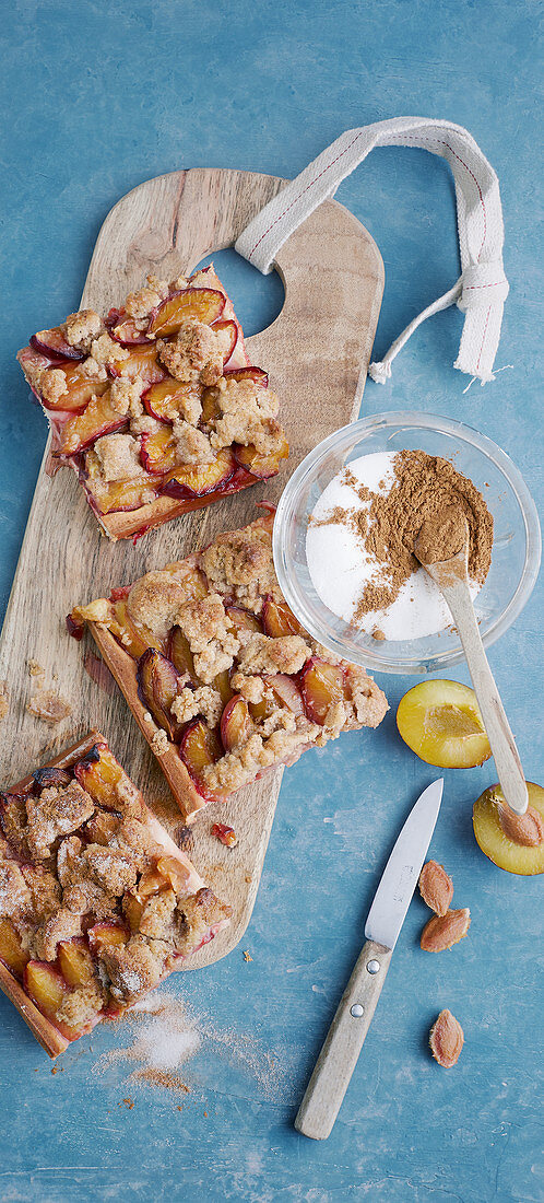Pieces of plum cake with nut crumble on a board