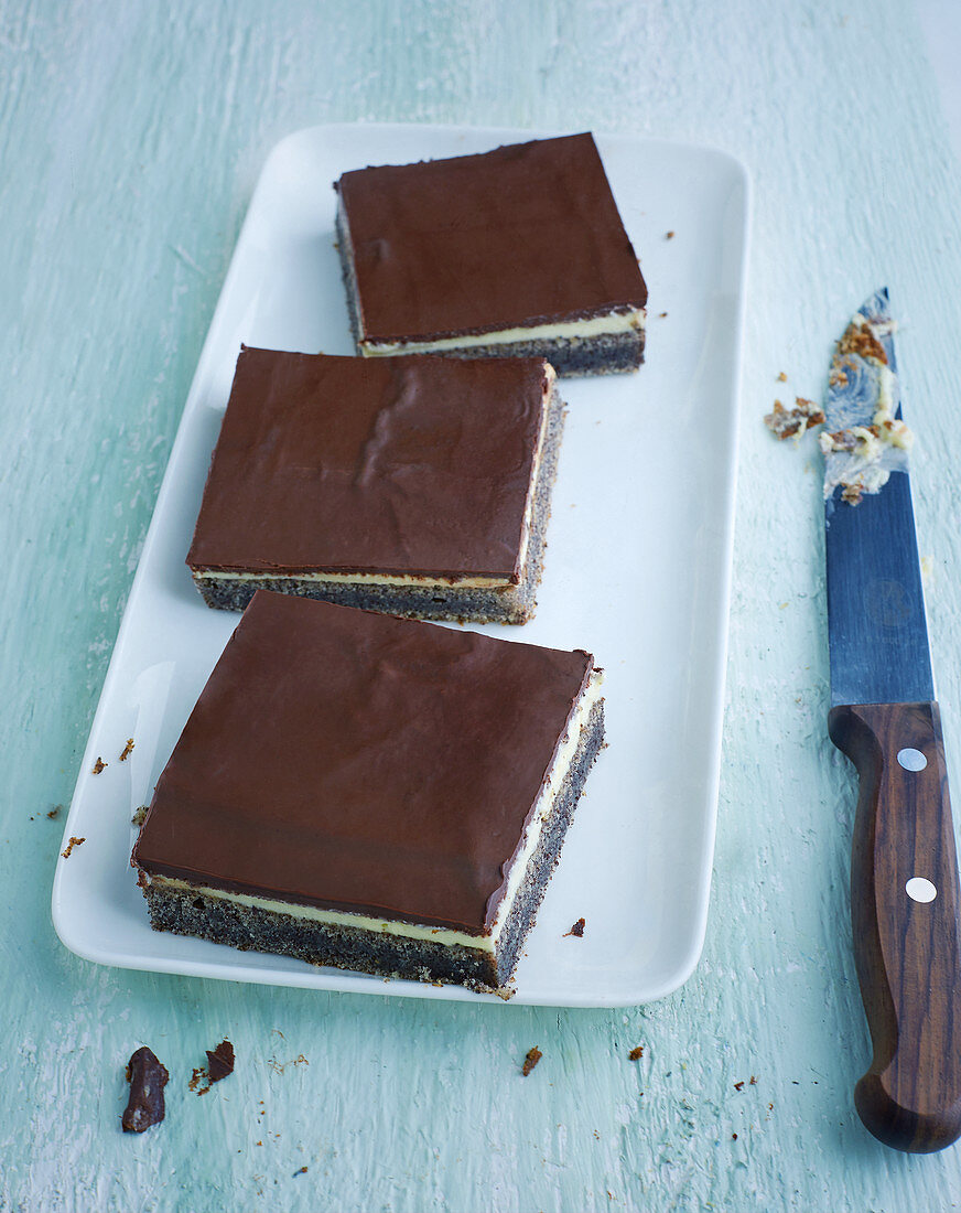 Three creamy poppyseed slices on a platter