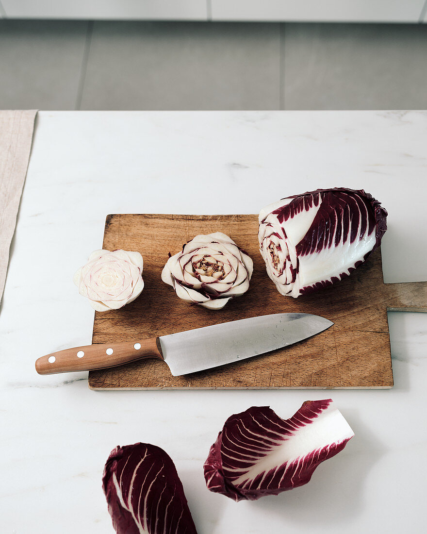 Radicchio with a knife on a wooden board