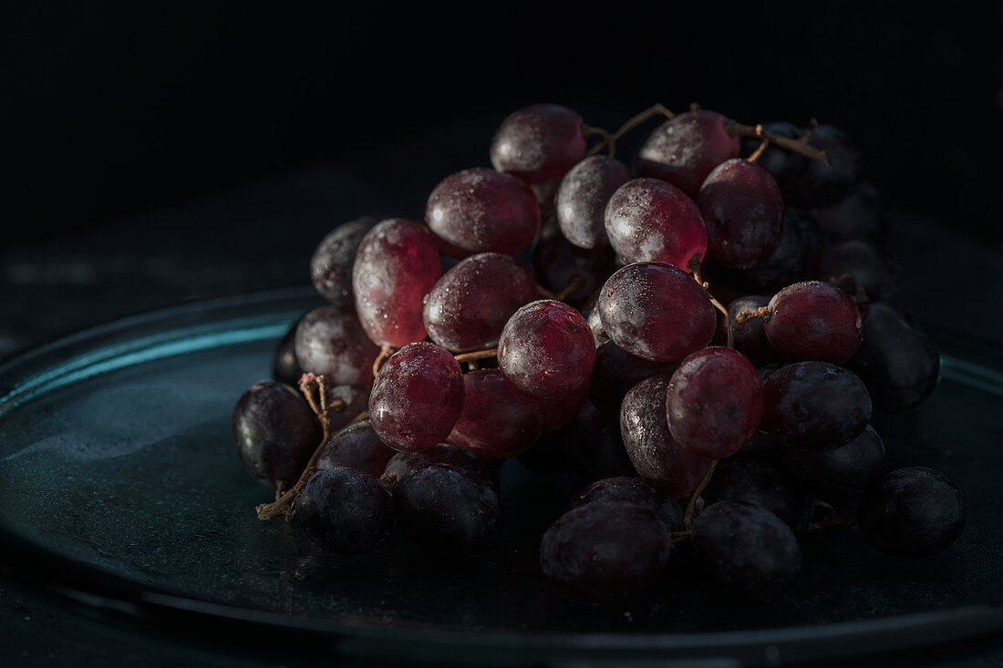 Red grapes against a dark background
