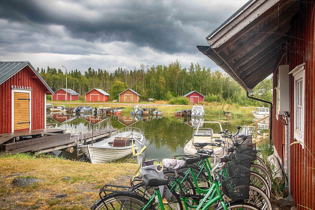 Fishing houses on the Archipelago Sea with bikes parked in the foreground, Finland