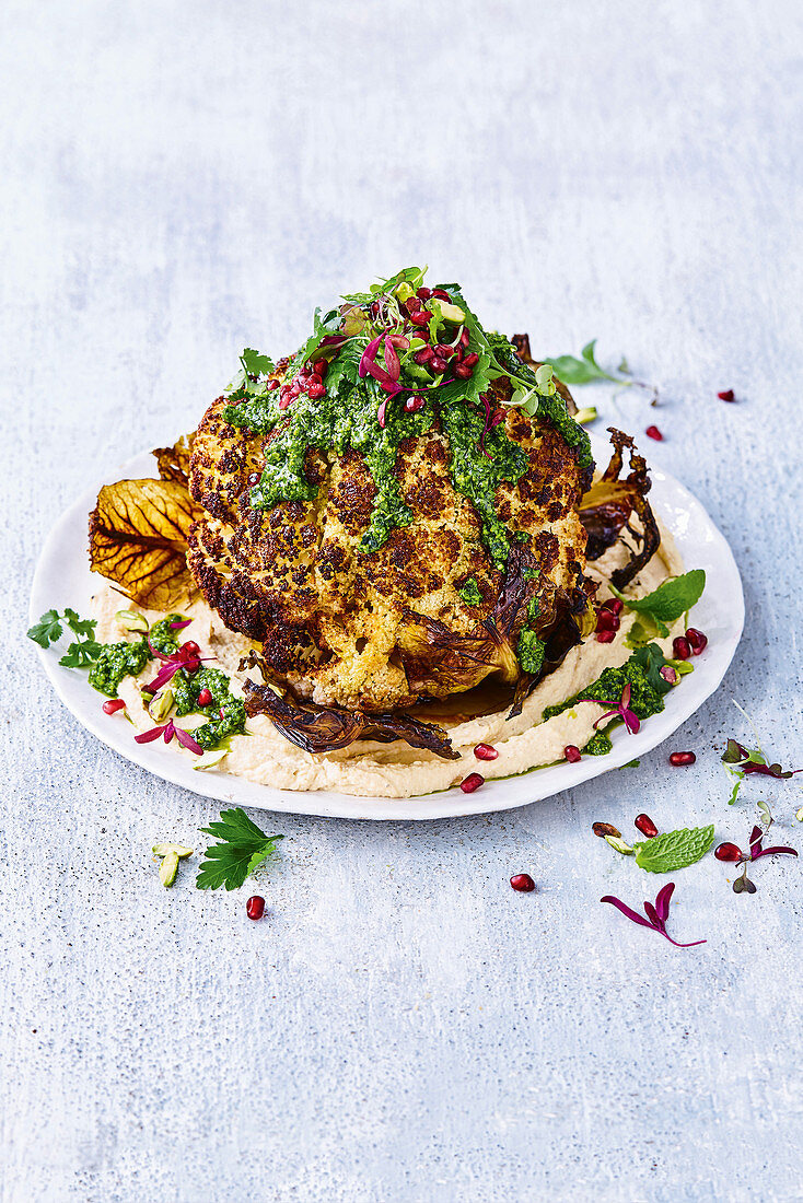 Roast cauliflower with hummus and green herb dressing