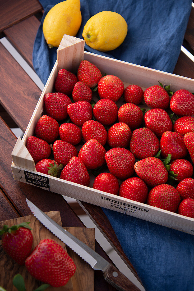 Fresh strawberries in a wooden crate
