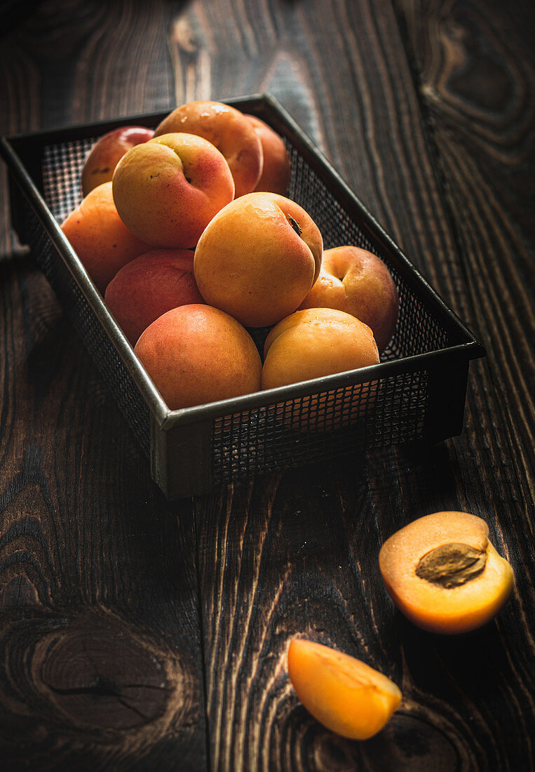 Aprikosen im Korb auf Holztisch