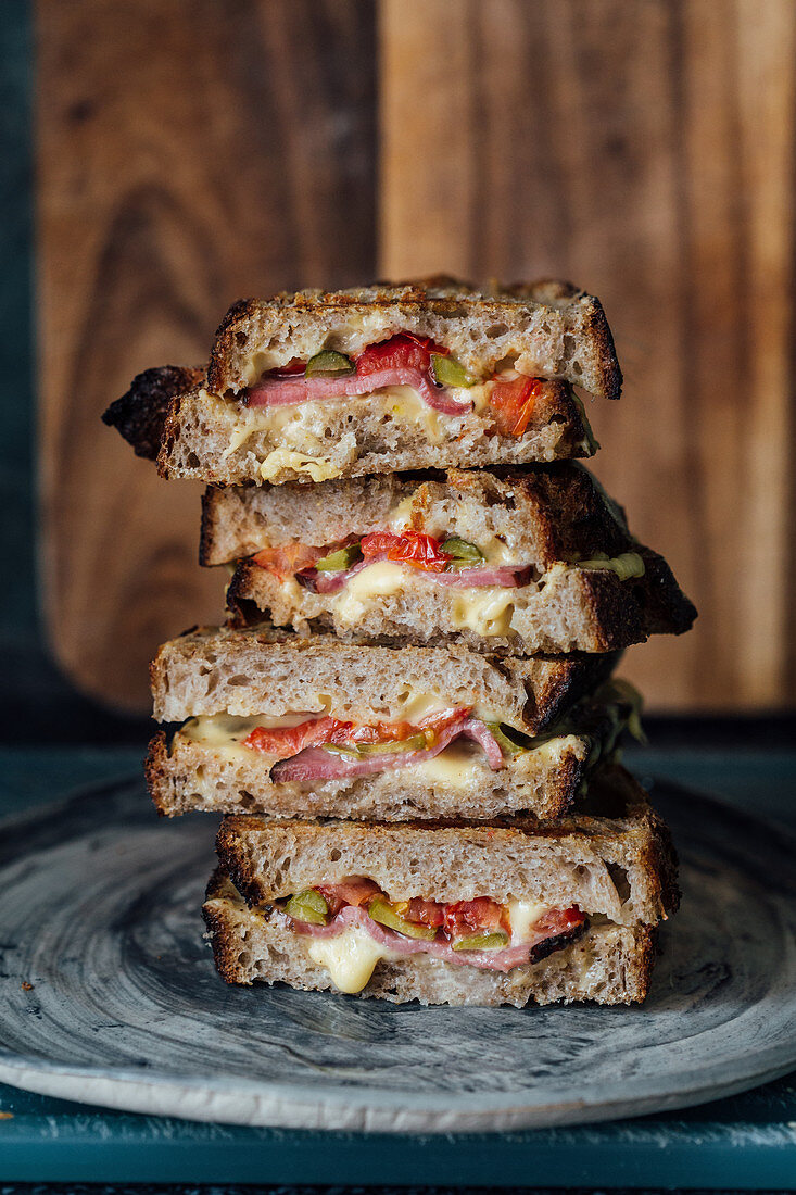 Sandwich with cheese, roastbeef, tomatoes and cornichons