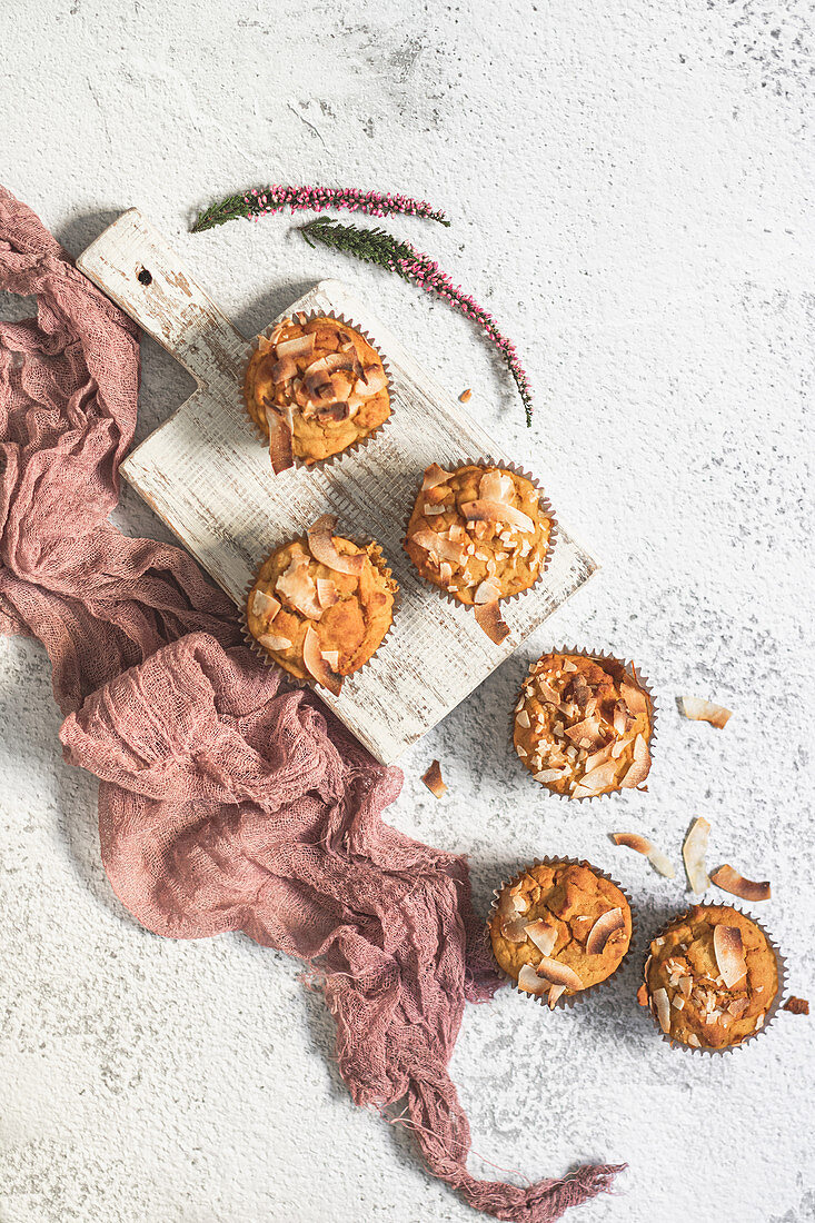 Vegan and glutenfree pumpkin muffins with coconut flakes