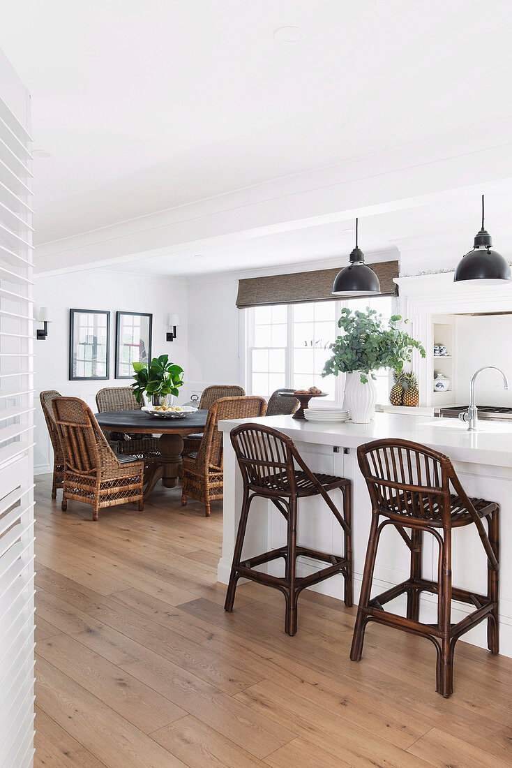 Open colonial style living room with dining table and open kitchen