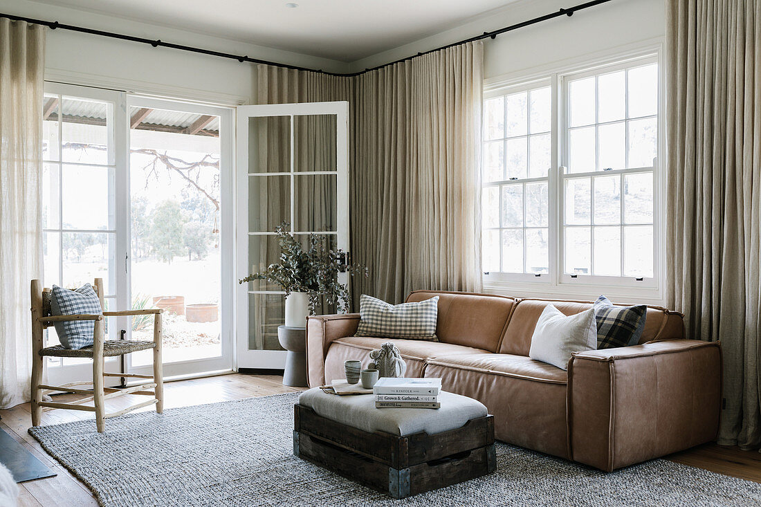 Leather sofa in the rustic living room in earth colours