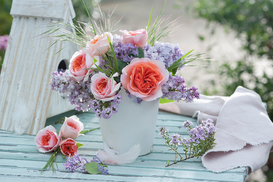 Small bouquet of roses and lilacs, flowering thyme branch