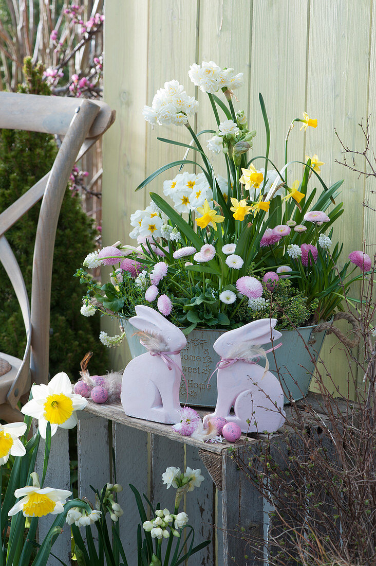 Sheet metal bowl with daffodils, primroses, daisies and grape hyacinths, Easter bunnies and Easter eggs