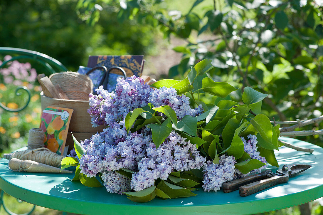 Freshly cut branches of lilac on the patio table