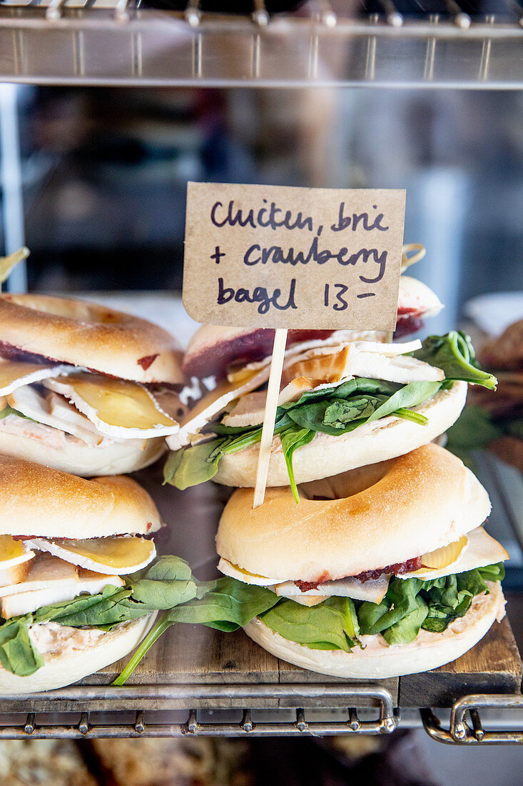 Bagels with chicken breast, brie cheese and cranberries on a sales counter