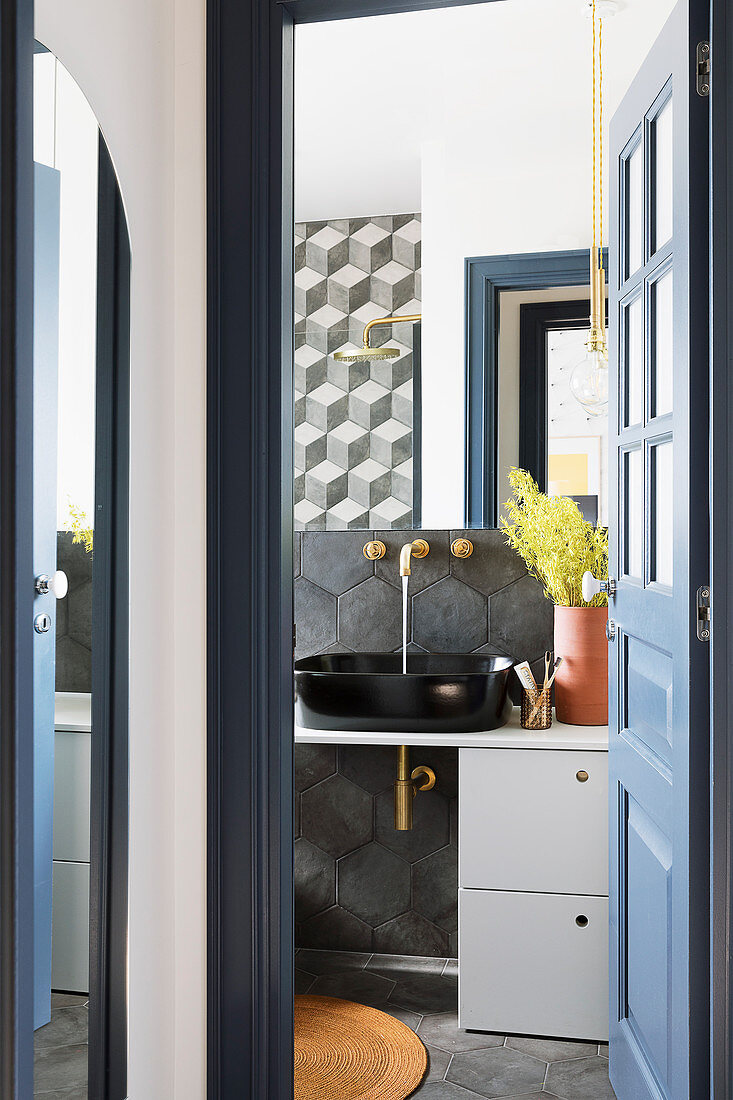 View through open, blue panelled door into modern bathroom